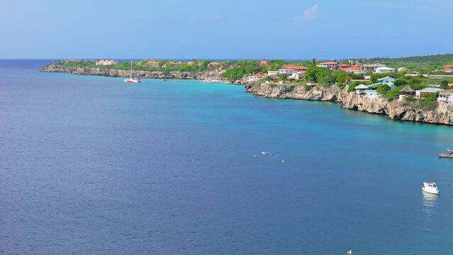 Aerial orbit around Playa kalki and catamaran in distance, Westpunt Curacao