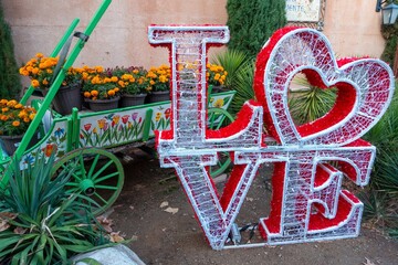 Christmas Lights, Inspirational Love Text Message, Vintage Old Wagon Cart Background.  Tlaquepaque Spanish Village of Arts and Crafts, Sedona Arizona USA