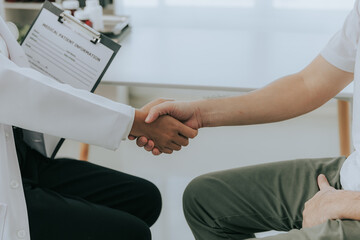 A doctor is counseling a young male patient about prostate cancer and venereal disease, including...