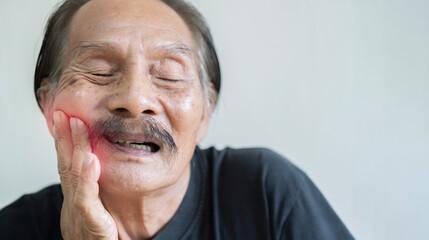 Dental pain, Portrait of retired man suffering from toothache, teeth prosthetics, dentistry.