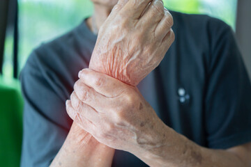 Elderly male patient suffer from numbing pain in hand, numbness fingertip, arthritis inflammation