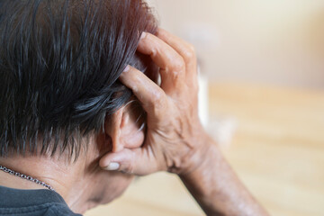 Rear view of elderly patients, Asian senior man patients headache hands on forehead - medical and...