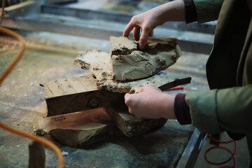 The craftsmanship begins with selecting the perfect piece, as a woodworker s hands assess the...