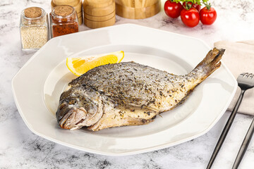 Baked Dorado fish served lemon