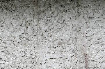 The background of an old wall decorated with gray cement mortar