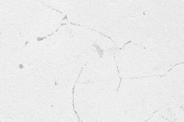 An old wall with a cracked texture is decorated with cement mortar