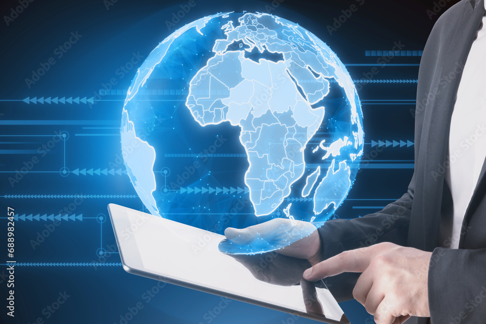 Aufkleber close up of businessman hands using pad with bright blue globe hologram and lines on blurry dark bac