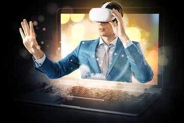 Abstract image of young european male with VR glasses stepping out of blurry bokeh laptop screen on...