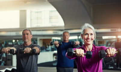 Naklejka premium Senior fitness club, dumbbells and people at gym for training, health and wellness, sport or exercise. Class, workout and elderly group of friends at a studio for hand weight, cardio or weightlifting