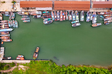 Fototapeta na wymiar High angle view fisherman boats at the jetty located in Phuket Thailand, aerial view drone top down view,Siray fishing port Phuket Thailand