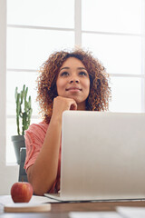 Woman thinking, web design student or laptop for research, technology or internet in office....