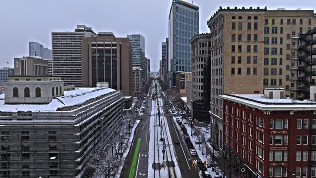 Salt Lake City skyline on winter's day, TRAX light rail system in transit. Drone