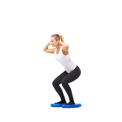 Balance, exercise and fitness with woman on disc in studio for workout, mindfulness or squats. Wellness, challenge and training with person on white background for flexibility, smile or aerobics