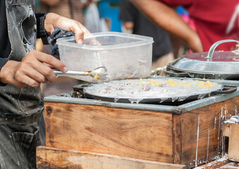 Thai Pancake, Male hands making khanom krok Traditional Thai desserts with delicious - obrazy, fototapety, plakaty