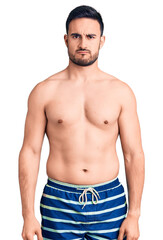 Fototapeta premium Young handsome man wearing swimwear skeptic and nervous, frowning upset because of problem. negative person.