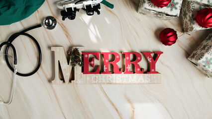 Merry Christmas sign with medical instruments flat background 
