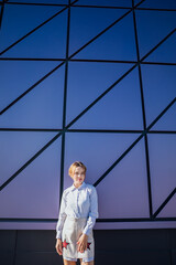 Beautiful fashionable woman near glass wall showcase