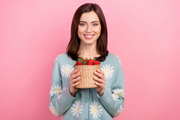Photo of shiny cute lady wear turquoise clothes smiling holding strawberry basket isolated pink...