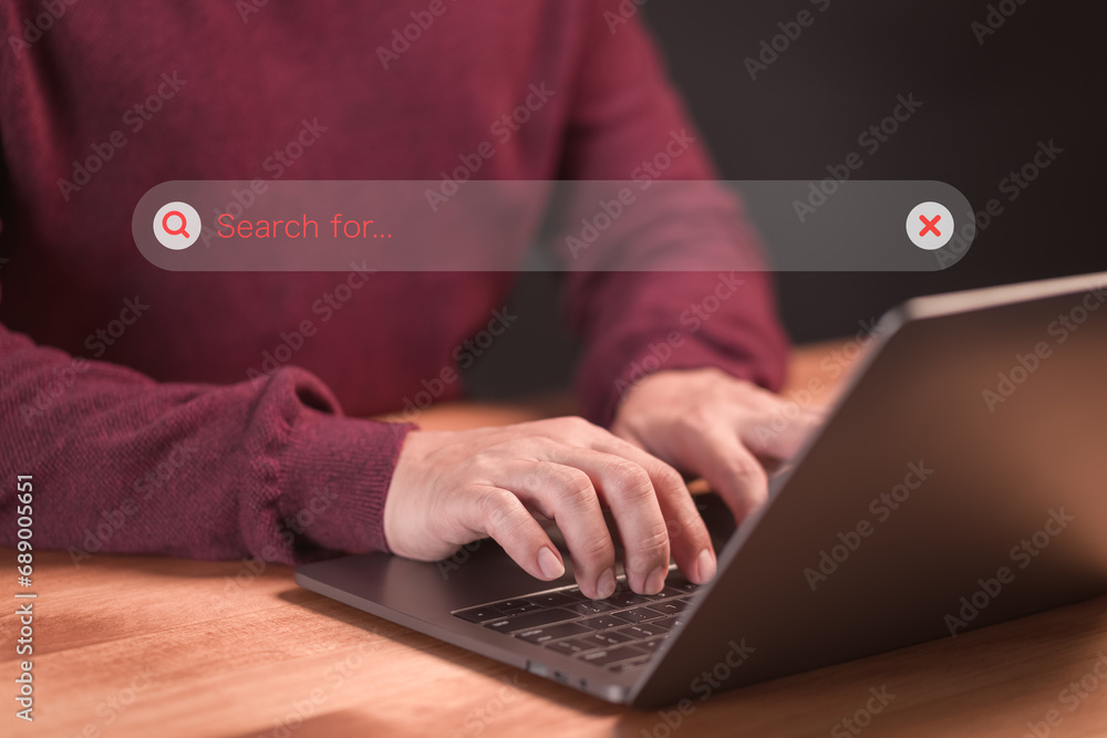 Poster Man using a laptop computer clicking internet search bar. SEO technology networking engine optimization internet with search bar. Searching browsing internet data information concept.