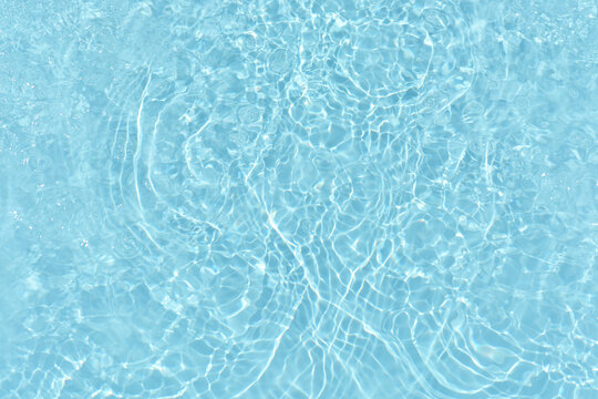 Bluewater bubbles on the surface ripples. Defocus blurred transparent white-black colored clear calm water surface texture with splash and bubbles. Water waves with shining pattern texture background.
