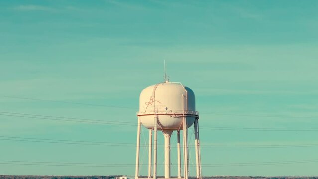 Aerial drone rise up of Georgetown, Texas suburban water tower in neighborhood of sunny fall day