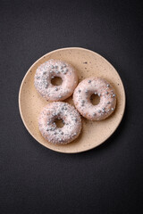 Delicious fresh donut of white or beige color with silver beads and cream