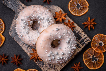 Delicious fresh donut of white or beige color with silver beads and cream