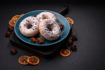 Delicious fresh donut of white or beige color with silver beads and cream