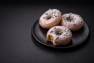 Delicious fresh donut of white or beige color with silver beads and cream