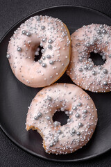 Delicious fresh donut of white or beige color with silver beads and cream