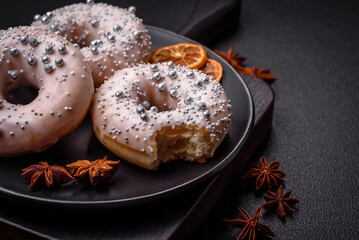 Delicious fresh donut of white or beige color with silver beads and cream