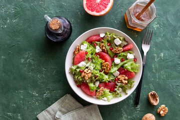 Salad with grapefruit, white cheese, pomegranate and nuts. Healthy eating. Vegetarian food. Diet.