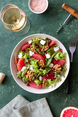 Salad with grapefruit, white cheese, pomegranate and nuts. Healthy eating. Vegetarian food. Diet.