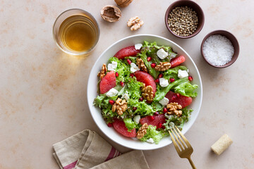 Salad with grapefruit, white cheese, pomegranate and nuts. Healthy eating. Vegetarian food. Diet.