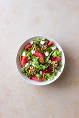 Salad with grapefruit, white cheese, pomegranate and nuts. Healthy eating. Vegetarian food. Diet.