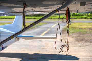 Fototapeta premium Rope hanging on small plane in airfield