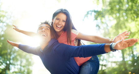 Outdoor, piggy back and couple with love, nature and summer with lens flare, marriage and...