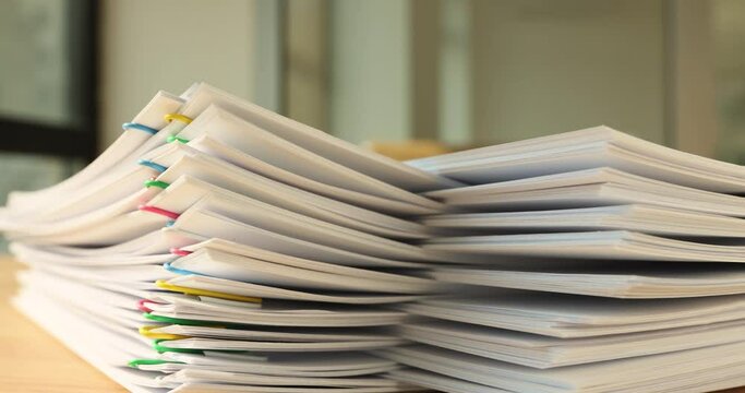 A stack of paper with colored paper clips, timelapse, Organization of document circulation, vertical papers clip