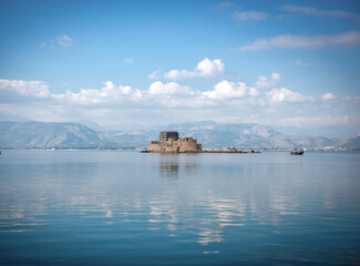 View of old Venetian fortress and old prison, Bourtzi at the sea. Argolis bay, Nafplio - Greece