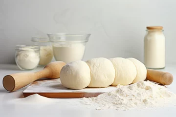 Foto op Plexiglas Rolling wooden pin, flour and fresh yeast dough against a white kitchen with minimalist interior design, homemade bakery.  © dinastya