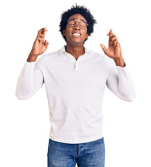 Handsome african american man with afro hair wearing casual clothes and glasses gesturing finger...