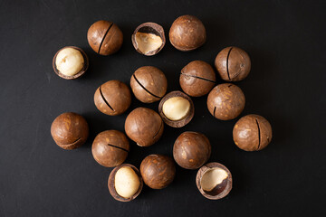 Close up macadamia nuts on black background.