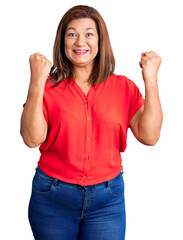 Middle age latin woman wearing casual clothes screaming proud, celebrating victory and success very excited with raised arms