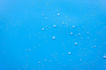 Water or rain drops on blue background 