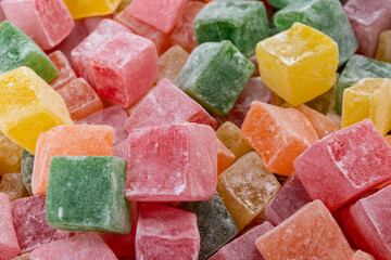 Closeup of multicolored cubes Turkish delight (Lokum). Selective Focus. Flat lay.