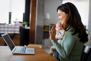 Family technology motherhood concept. Happy smiling young mother with baby. Video communication