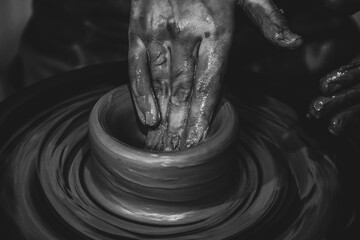 Pottery. The oldest trade from Daco-Roman times. Hands dirty with clay. Ceramics. Modeling in clay. Color and black-and-white detail photos.