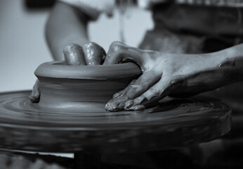 Pottery. The oldest trade from Daco-Roman times. Hands dirty with clay. Ceramics. Modeling in clay. Color and black-and-white detail photos.
