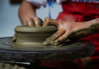 Pottery. The oldest trade from Daco-Roman times. Hands dirty with clay. Ceramics. Modeling in clay. Color and black-and-white detail photos.