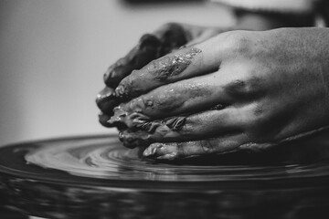 Pottery. The oldest trade from Daco-Roman times. Hands dirty with clay. Ceramics. Modeling in clay. Color and black-and-white detail photos.